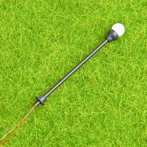 Close-up detail of miniature plastic street lamp model with wire for DIY moss landscape decor.