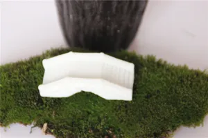 Detail shot of white resin miniature bridge for micro landscape decoration and moss DIY setup.