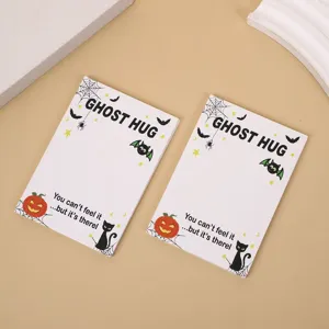Detail view of Halloween ghost hug greeting cards with cute pumpkin and cat illustrations.
