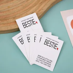 Close-up detail of pocket hug bestie greeting cards with heartfelt friendship text print.