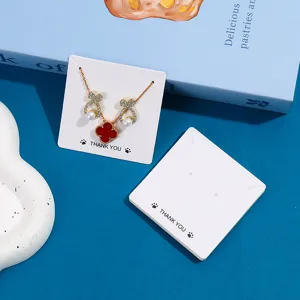 White cardboard necklace display cards with elegant jewelry packaging design for retail.