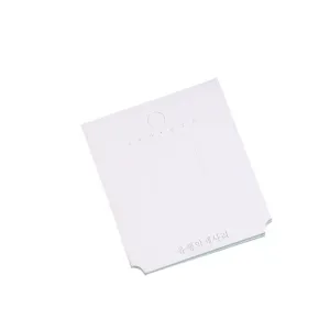 White paper jewelry display card for hair clips and earrings with hanging hole and slots.