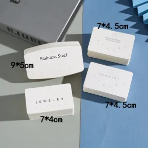 White paper jewelry display cards with multi-holes for earrings, necklaces, and brooches.