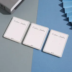 White paper earring cards display holders for jewelry packaging and retail showcasing studs.