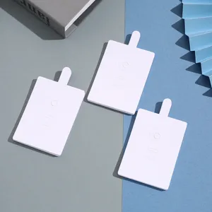 Detailed view of white foldable ring display cards, blank paper packaging for jewelry.