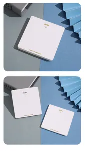Close-up detail of white square jewelry display cards with gold foil hello text and smile.