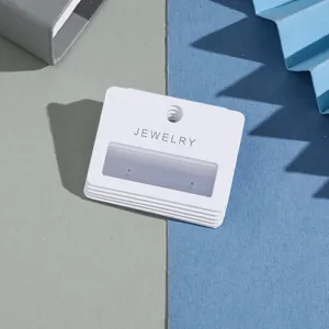 White paper earring display cards with hanging hole and window, ideal for jewelry packaging.