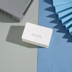 White multi-hole earring display card paper holder for jewelry packaging, minimalist design.