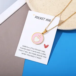 Gold chain necklace with pink heart pendant on pocket hug message card for gift giving.