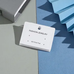 Detailed view of white earring display cards with multiple holes, perfect for jewelry packaging.