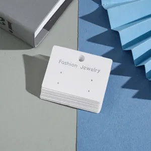 White paper earring display cards with multi-holes for jewelry packaging and retail use.