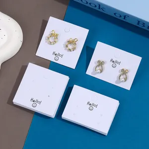 Jewelry display cards packaging set with pearl bow earrings for retail presentation.