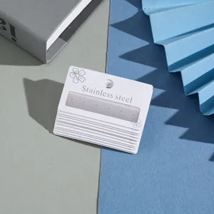 Detailed view of white earring cards with multi-hole paper packaging for jewelry display studs