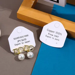 Exquisite pearl stud earrings set on custom paper cards with elegant design, fashion jewelry.