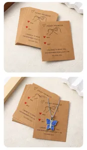 Detail view of retro kraft paper blessing cards and blue butterfly necklace pendant accessory.