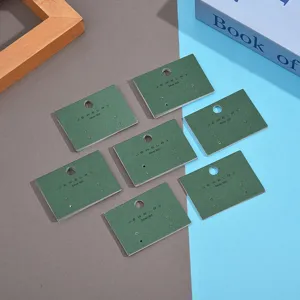 Green paper jewelry display cards for earrings and studs, elegant packaging tool.
