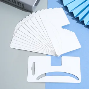 Detail shot of white blank hair claw packaging cards, large size design for hair accessories display.