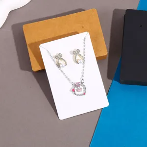 Rhinestone heart butterfly necklace and earrings jewelry set on display card for women.