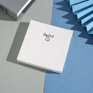 White multi-hole earring display card with cute smile design for jewelry packaging & retail.