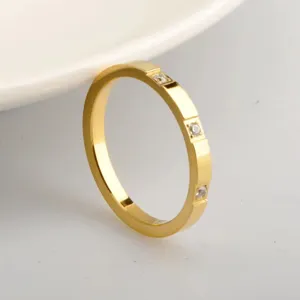 Minimalist gold titanium steel ring with paved cubic zirconia, delicate stackable band.