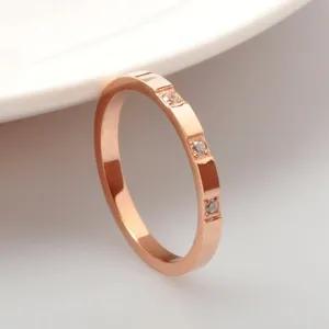 Minimalist rose gold titanium steel ring with sparkling cubic zirconia stones for elegant women.