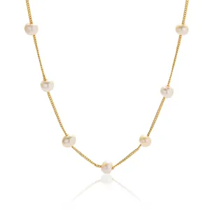 Close-up detail of the elegant freshwater pearl station gold chain necklace, delicate design.