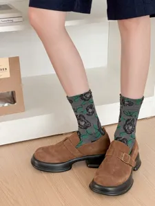 Detail view of women retro floral mid-calf socks paired with brown platform shoes for autumn wear.