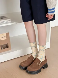 Detail view of women retro floral print mid-calf socks paired with brown casual shoes.