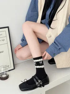 Japanese style bow women mid-calf socks paired with classic black Mary Jane shoes for daily wear.
