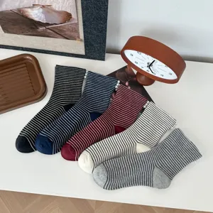 Detailed view of women's autumn winter striped slouch socks with elegant side pearl decorations.
