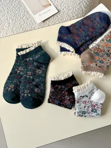 Close-up detail of vintage floral short socks featuring delicate lace ruffle cuffs.