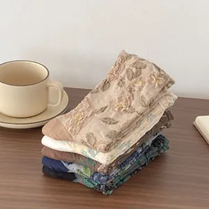 Detailed close-up of vintage floral jacquard mid-tube women socks, aesthetic lifestyle desktop setup.