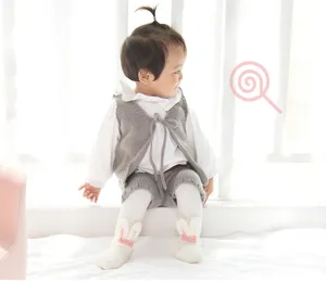 Cute baby bunny coral fleece socks and soft knit vest outfit detail view for little kids