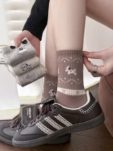 Cozy cotton mid-calf socks featuring cute cartoon dog embroidery and stylish retro patterns.