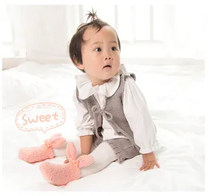 Cute baby rabbit coral fleece socks with 3D ears, soft and warm infant footwear detail.