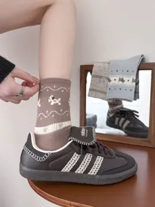 Cute brown cotton mid-calf socks with adorable puppy and bow embroidery details, detail shot
