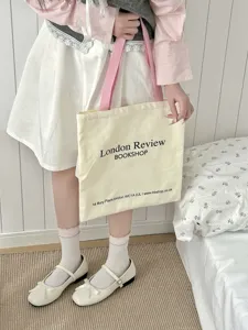 Detailed shot of frilly cute socks paired with canvas tote bag and Mary Jane shoes.