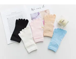 Detail shot of women's mesh five-toe socks in assorted solid colors, breathable and soft.