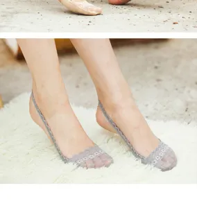 Detailed close-up view of women gray lace low-cut invisible boat socks worn on feet display