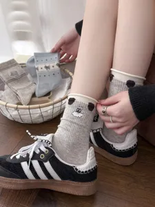 Cute cartoon embroidered grey mid-calf socks for women, soft cotton ribbed detail in daily wear.
