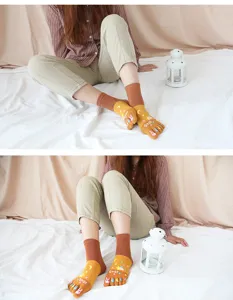 Detailed view of women's cute cartoon five-finger mid-tube socks with cozy cotton fabric.