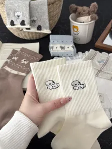 Detail view of cute cartoon puppy embroidered cotton mid-tube socks, soft texture and cozy wear.