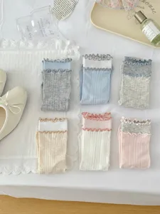 Detailed view of Japanese style double-layer ruffled mid-tube cotton socks in various soft colors.