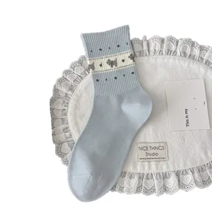 Light blue cotton crew socks featuring cute knitted puppy and heart patterns for women.