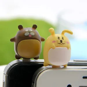 Cute cartoon couple dust plug detail shot showing cute animal figures for mobile phones.