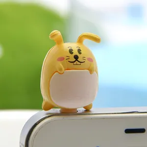 Close-up detail of cute yellow bunny cartoon 3.5mm dust plug plugged into smartphone.