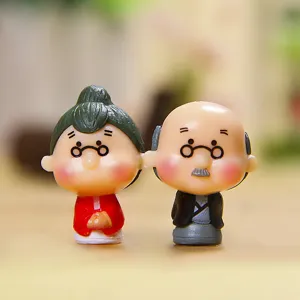 Detailed macro shot of cute elderly couple miniature figurines, resin craft ornament.