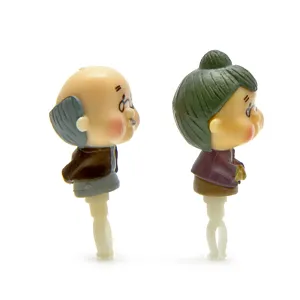 Cute cartoon old couple figurine detail view, miniature desktop decoration and accessory close up
