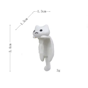 Cute white cartoon cat dust plug for 3.5mm headphone jack, portable and compact size.