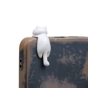 Cute white cat dust plug figurine detail shot, hanging cute animal phone accessory charm decoration.